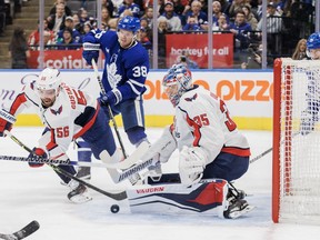 Toronto Maple Leafs defenceman Rasmus Sandin (38) looks for a rebound as Washington Capitals defenceman Erik Gustafsson (56) tries to clear the puck in front of goaltender Darcy Kuemper (35) during second period NHL action in Toronto on Sunday, Jan. 29, 2023.&ampnbsp;The Toronto Maple Leafs traded Rasmus Sandin to the Washington Capitals for fellow defenceman Erik Gustafsson and a first-round pick at the 2023 NHL draft on Tuesday.