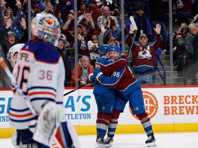Colorado Avalanche right wing Mikko Rantanen (96) celebrates his overtime winning goal with left wing J.T. Compher (37) as Edmonton Oilers goaltender Jack Campbell (36) skates away in overtime at Ball Arena on Feb. 19. 2023.