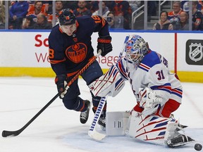 Feb 17, 2023; Edmonton, Alberta, CAN; Edmonton Oilers forward Zach Hyman (18) deflects a shot just wide of New York Rangers goaltender Igor Shesterkin (31) during the first period at Rogers Place. Mandatory Credit: Perry Nelson-USA TODAY Sports