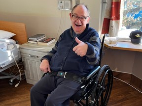 An ecstatic Cam Tait, happy to be out of care after five weeks at the University of Alberta Hospital, gives the thumbs up. Supplied