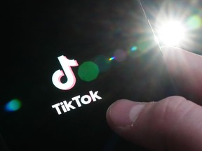 The TikTok startup page is displayed on an iPhone in Ottawa, Monday, Feb. 27, 2023. The House of Commons announced on Tuesday that it's banning the application from all House-managed devices, effective March 3, 2023.