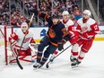 Leon Draisaitl (29) of the Edmonton Oilers, chases the puck into the corner in front of goalie Ville Husso (35) of the Detroit Red Wings at Rogers Place in Edmonton on February 15, 2023.