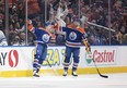 Edmonton Oilers' Connor McDavid (97) and Mattias Ekholm (14) celebrate a goal against the Toronto Maple Leafs.