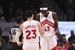 Toronto Raptors forward Pascal Siakam celebrates with guard Fred VanVleet after scoring during overtime against the Washington Wizards.