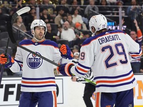 LAS VEGAS, NEVADA - MARCH 28: Evan Bouchard #2 and Leon Draisaitl #29 of the Edmonton Oilers celebrate Bouchard's first-period power-play goal against the Vegas Golden Knights during of their game at T-Mobile Arena on March 28, 2023 in Las Vegas, Nevada.
