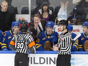 Edmonton Oil Kings head coach Luke Pierce converses with officials in a game against the Swift Current Broncos at Rogers Place in Edmonton on Dec. 16, 2022. The Broncos won 8-4.