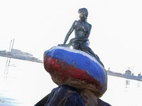 The Little Mermaid sculpture, the emblem of Copenhagen and Denmark, is pictured Thursday, March 2, 2023, after it had been vandalized with the colours of the Russian flag painted on the stone she sits on.