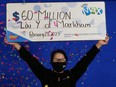 Lai Ching Yau of Markham holds her giant $60-million Lotto Max cheque.