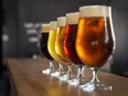 Glasses of craft beer on a wooden bar.