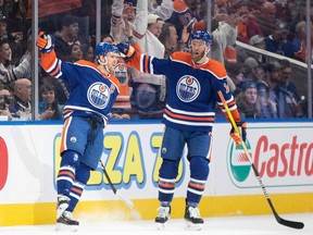 Connor McDavid (97) and Mattias Ekholm (14) of the Edmonton Oilers celebrate a goal against the Toronto Maple Leafs during first period NHL action in Edmonton on Wednesday, March 1, 2023.