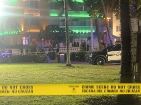 Crime scene tape is shown at the scene along Ocean Drive in Miami Beach, Fla. Friday, March 17, 2023, where police say one person was killed and a second was wounded when gunfire erupted in an area crowded with people on spring break.