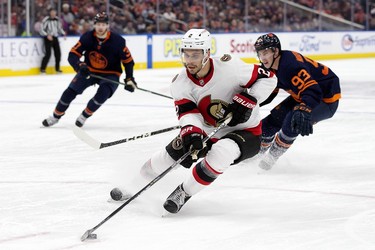 The Ottawa Senators' Artem Zub (2) battles the Edmonton Oilers' Ryan Nugent-Hopkins (93) during third period NHL action at Rogers Place in Edmonton, Tuesday March 14, 2023. The Oilers won 6-3.