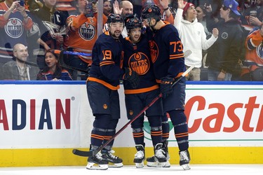 The Edmonton Oilers' Devin Shore (19) Derek Ryan (10) and Vincent Desharnais (73) celebrate Ryan's goal against the Ottawa Senators during first period NHL action at Rogers Place in Edmonton, Tuesday March 14, 2023.