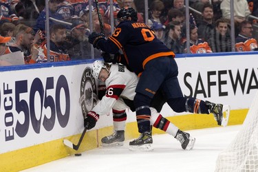 The Edmonton Oilers' Ryan Nugent-Hopkins (93) checks the Ottawa Senators' Erik Brannstrom (26) during first period NHL action at Rogers Place in Edmonton, Tuesday March 14, 2023.