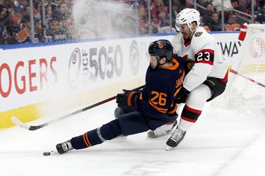 The Edmonton Oilers' Mattias Janmark (26) battles the Ottawa Senators' Travis Hamonic (23) during first period NHL action at Rogers Place in Edmonton, Tuesday March 14, 2023.