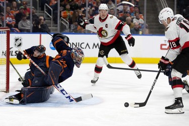 The Edmonton Oilers' Nick Bjugstad (72) makes a save against the Ottawa Senators' Tim Stutzle (18) during second period NHL action at Rogers Place in Edmonton, Tuesday March 14, 2023.
