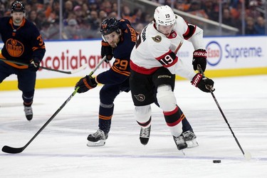 The Edmonton Oilers' Leon Draisaitl (29) battles the Ottawa Senators' Drake Batherson (19) during second period NHL action at Rogers Place in Edmonton, Tuesday March 14, 2023.