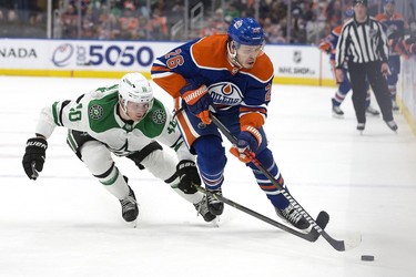 The Edmonton Oilers' Mattias Janmark (26) battles the Dallas Stars' Ty Dellandrea (10) during third period NHL action at Rogers Place in Edmonton, Thursday March 16, 2023. The Oilers won 4-1.