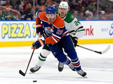 The Edmonton Oilers' Leon Draisaitl (29) battles the Dallas Stars' Roope Hintz (24) during first period NHL action at Rogers Place in Edmonton, Thursday March 16, 2023.