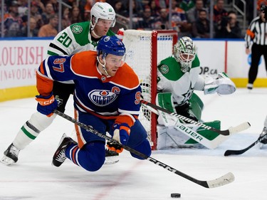 The Edmonton Oilers' Connor McDavid (97) battles the Dallas Stars' Ryan Suter (20) during first period NHL action at Rogers Place in Edmonton, Thursday March 16, 2023.