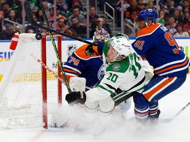 The Edmonton Oilers' Evander Kane (91) battles the Dallas Stars Ty Dellandrea (10) in front of goalie Stuart Skinner (74) during second period NHL action at Rogers Place in Edmonton, Thursday March 16, 2023.