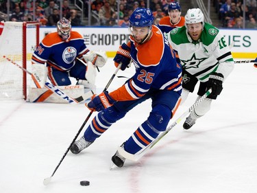 The Edmonton Oilers' Darnell Nurse (25) battles the Dallas Stars' Joe Pavelski (16) during second period NHL action at Rogers Place in Edmonton, Thursday March 16, 2023.