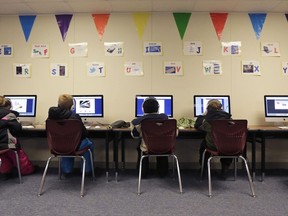 Watford City Elementary School students use computers in a portable building in Watford City, N.D., Dec. 17, 2014. The North Dakota House passed a bill Wednesday, March 22, 2023, that would prohibit schools from requiring teachers to call students by the pronouns they use, if those pronouns differ from what was assigned at birth.