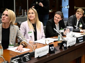 Canadian National Soccer Team players Sophie Schmidt, left Janine Beckie, Christine Sinclair, and Quinn, are greeted as they prepare to appear before the Standing Committee on Canadian Heritage in Ottawa, studying safe sport in Canada, on Thursday, March 9, 2023.