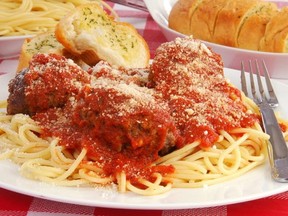 A plateof spaghetti and meat balls with garlic toast