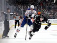 LOS ANGELES, CALIFORNIA - APRIL 21: Mikey Anderson #44 of the Los Angeles Kings checks Klim Kostin #21 of the Edmonton Oilers at the blueline during the first period in Game Three of the First Round of the 2023 Stanley Cup Playoffs at Crypto.com Arena on April 21, 2023 in Los Angeles, California.