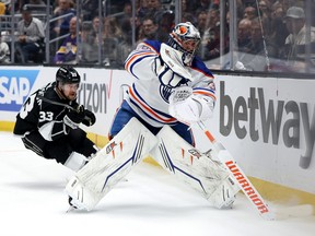 Jack Campbell of the Edmonton Oilers plays the puck away from Viktor Arvidsson of the Los Angeles Kings during the second period in Game 4.