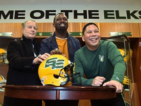 Unveiling the return to the double-E helmet design are, from left, Dan McKinnon, former assistant coach, Mookie Mitchell, former receiver-turned EE Football Alumni Association -president, and Victor Cui, Edmonton Elks president and CEO, at Commonwealth Stadium in Edmonton on March 3, 2022.