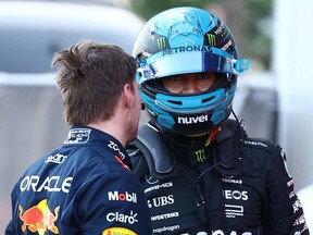 Red Bull's Max Verstappen talks with Mercedes' George Russell after the F1 sprint race in Baku, Azerbaijan on April 29, 2023.