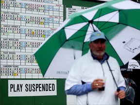 Patrons evacuate the grounds after play was suspended for the day due to weather conditions during the third round of the 2023 Masters Tournament at Augusta National Golf Club on Saturday.