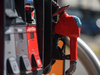 A gasoline pump hand hangs from the pump