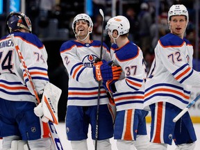 Edmonton Oilers defenceman Evan Bouchard (2) celebrates with left wing Warren Foegele (37), goaltender Stuart Skinner (74) and centre Nick Bjugstad (72) after the game against the Colorado Avalanche at Ball Arena on Tuesday, April 11, 2023.