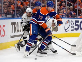 The Edmonton Oilers' Nick Bjugstad (72) and Brett Kulak (27) battles the Los Angeles Kings' Viktor Arvidsson (33) and Trevor Moore (12) during second period NHL playoff action at Rogers Place in Edmonton, Tuesday, April 25, 2023.