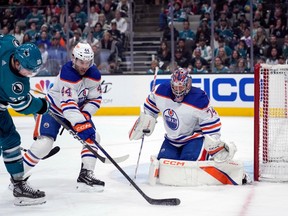 Edmonton Oilers goaltender Stuart Skinner, right, blocks a shot by San Jose Sharks left wing Fabian Zetterlund, left, during the second period of an NHL hockey game in San Jose, Calif., on April 8, 2023.