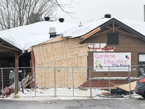 The scene outside a daycare centre in Laval, Que., Thursday, Feb. 9, 2023, where a bus crashed into the building, killing two children. A Montreal psychiatric hospital has completed its evaluation of the mental state of a man accused of killing two young children by driving a city bus into a daycare.