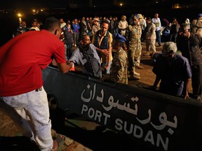 Evacuees board a tugboat at Port Sudan on April 30, 2023 during a rescue operation carried out by the Saudi navy.