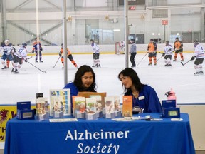 Volunteers man the information booth Saturday at the 14th annual Alzheimers's Face Off Pro-Am hockey tournament, a two-day event running Saturday and Sunday and hosted by Christenson Communities Ltd. at Terwillegar Rec Centre.