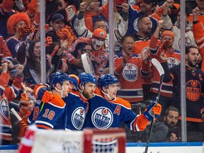Zach Hyman (18), Leon Draisaitl (29) and Ryan Nugent-Hopkins (93) of the Edmonton Oilers, celebrate the second Oilers goal in the first period against  the Los Angeles Kings at Rogers Place in Edmonton on April 19, 2023.