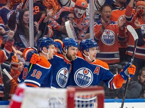 Zach Hyman (18), left, Leon Draisaitl (29) and Ryan Nugent-Hopkins (93) of the Edmonton Oilers celebrate the second Oilers goal in the first period against  the Los Angeles Kings at Rogers Place in Edmonton on Wednesday, April 19, 2023.