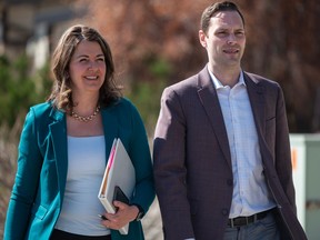 UCO Leader Danielle Smith is accompanied by UCP MLA Matt Jones as she walks to a news conference in Calgary to call the beginning of the 2023 provincial election on Monday, May 1, 2023.