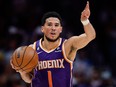 Phoenix Suns guard Devin Booker (1) controls the ball during a playoff game.