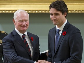 Canadian Prime Minister Justin Trudeau (R) shakes hands with Governor General David Johnston after being sworn in as prime minister at Rideau Hall in Ottawa on November 4, 2015.