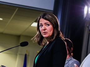 Danielle Smith standing at a podium. UCP Leader Danielle Smith speaks during a press conference in Calgary on Thursday, May 11, 2023.