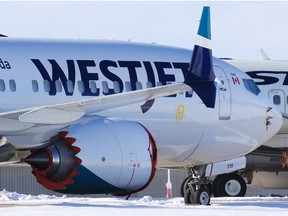 WestJet Boeing 737 MAX 8 registration number C-FHCM is parked in storage with older 737 aircraft on an unused runway at the Calgary International Airport on Thursday, February 25, 2021. C-FHCM was the aircraft WestJet used on the first commercial flight of company’s MAX 8 planes on January 21, 2021.