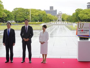 Canadian Prime Minister Justin Trudeau poses for a photo with Japan’s Prime Minister Fumio Kishida and his wife Yuko Kishida at the Peace Memorial Park during a visit as part of the G7 Hiroshima Summit in Hiroshima, Japan, May 19, 2023.