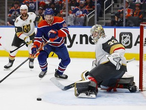 Edmonton Oilers forward Zach Hyman (18) chases a loose puck in front of Vegas Golden Knights goaltender Adin Hill (33) during the third period in game three of the second round of the 2023 Stanley Cup Playoffs at Rogers Place May 8, 2023.